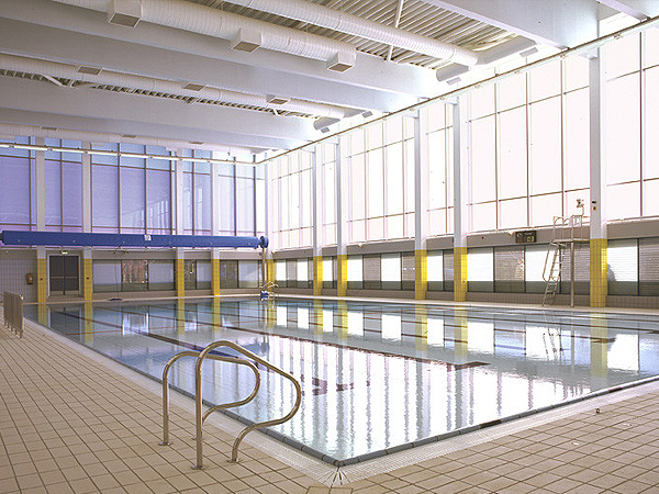 Indoor swimming pool hall with full-height glazing